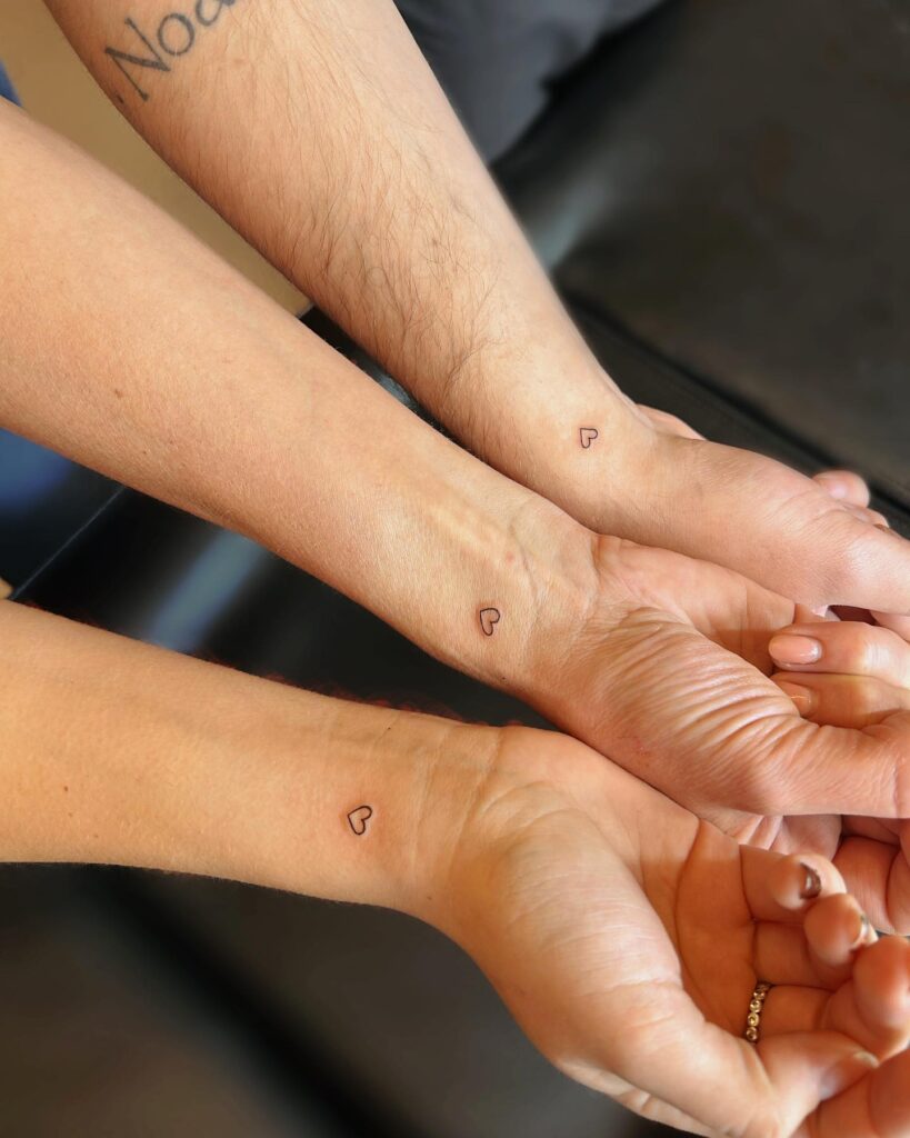 Micro Heart Silhouette on Outer Wrist matching family tattoo