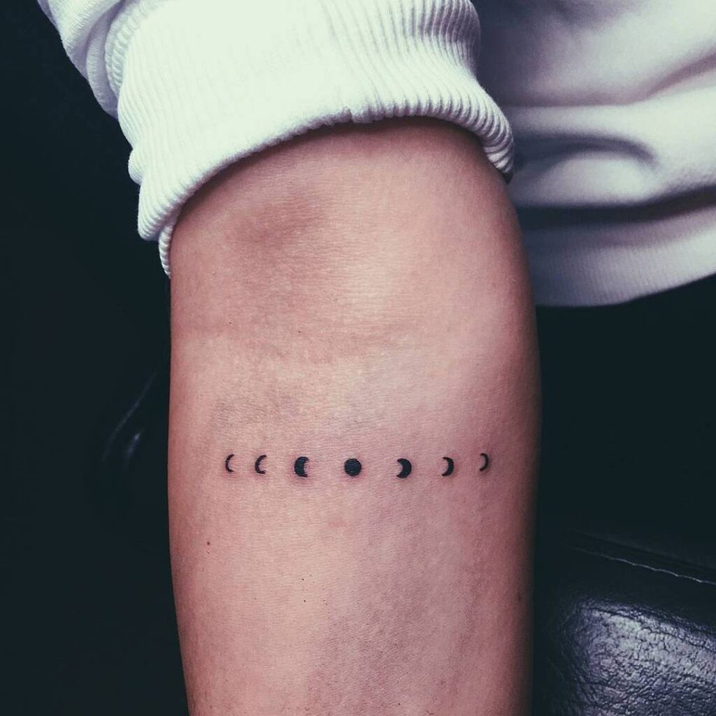 Tiny moon phases tattoo