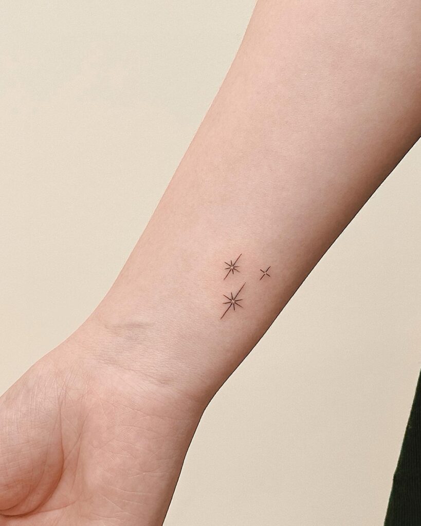 Minimal Sparkling Stars Wrist Tattoo meaningful tiny tattoos tattoo