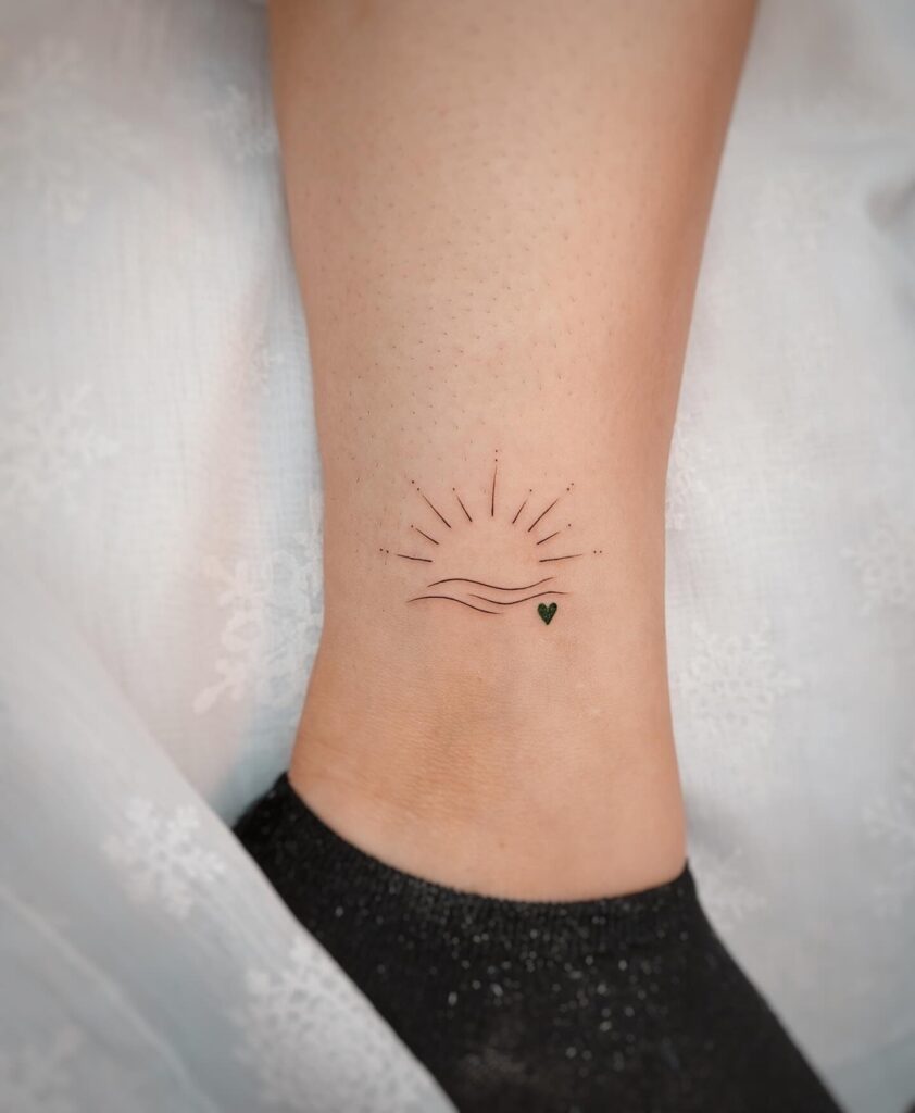 Minimal Sunrise Ankle Tattoo with Heart meaningful tiny tattoos tattoo