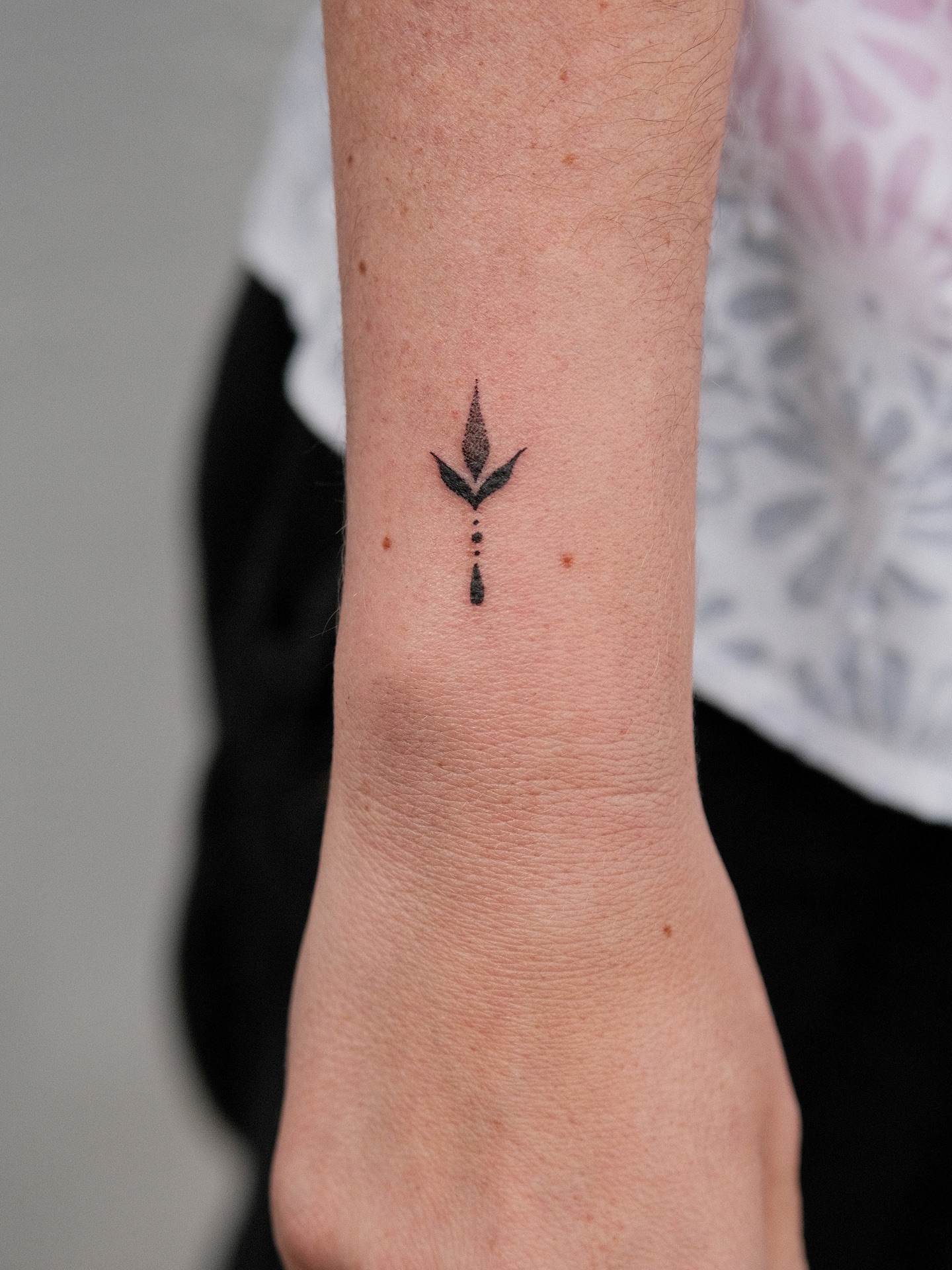 Minimal Symbol Wrist Tattoo