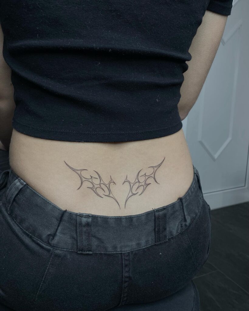 Pink And Black Tribal Heart Lower Back Tattoo