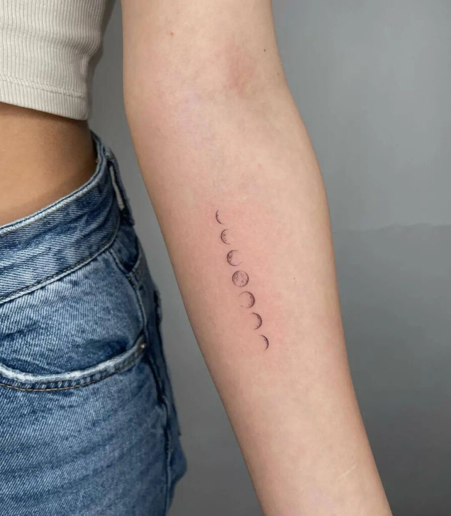Minimalist vertical moon phases tattoo