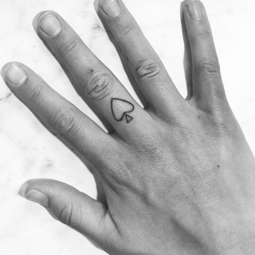 Playful Cartoon Devil And Trident Finger Tattoo