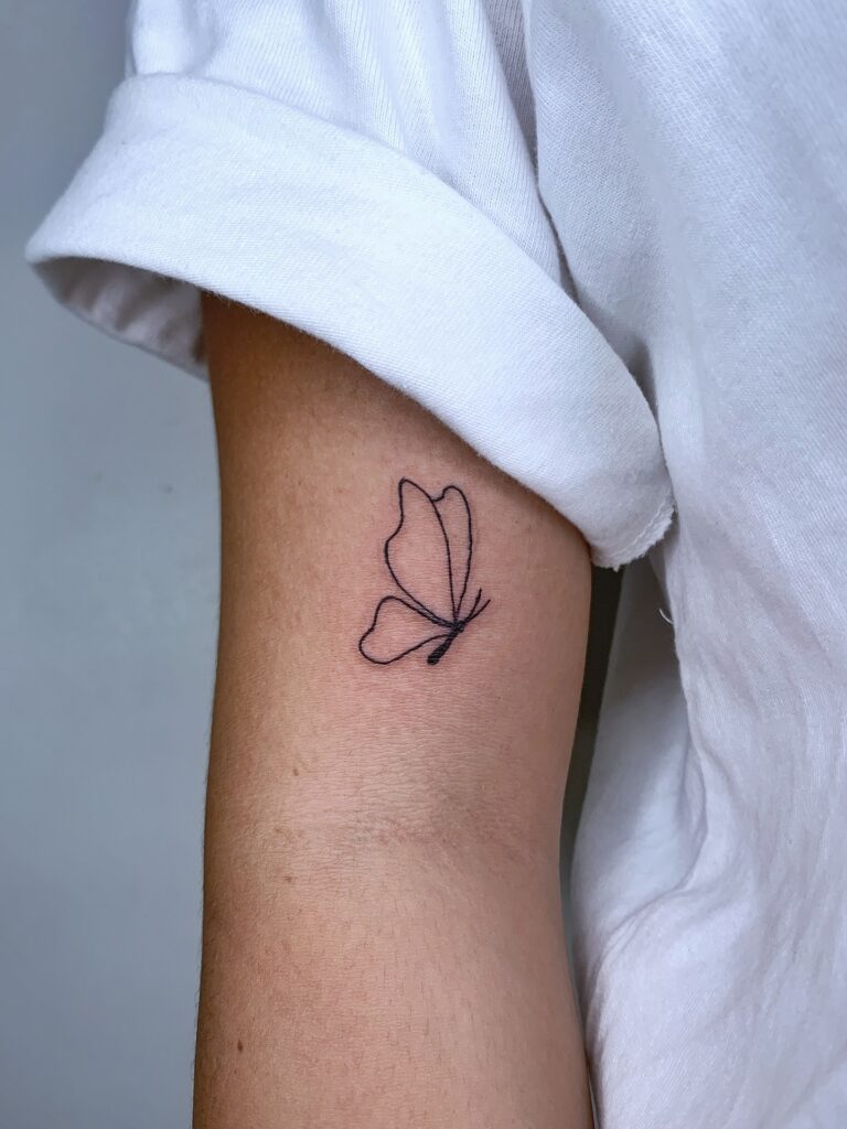 Minimalist Butterfly Outline on the Arm butterfly tattoo designs tattoo
