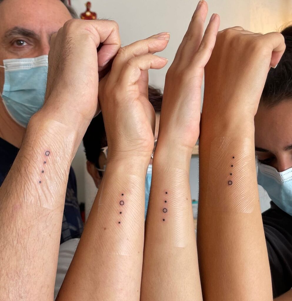 Minimalist Concentric Dots and Rings matching family tattoo