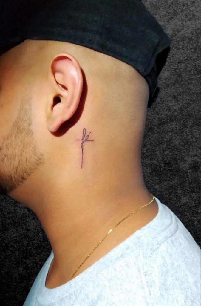 Minimalist Cross with &ldquo;Fe&rdquo; Behind the Ear Tattoo cross tattoos for men tattoo