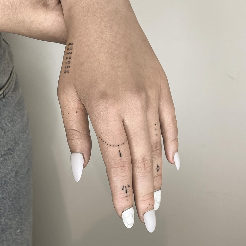 Delicate Hand Tattoo With Minimalist Motifs