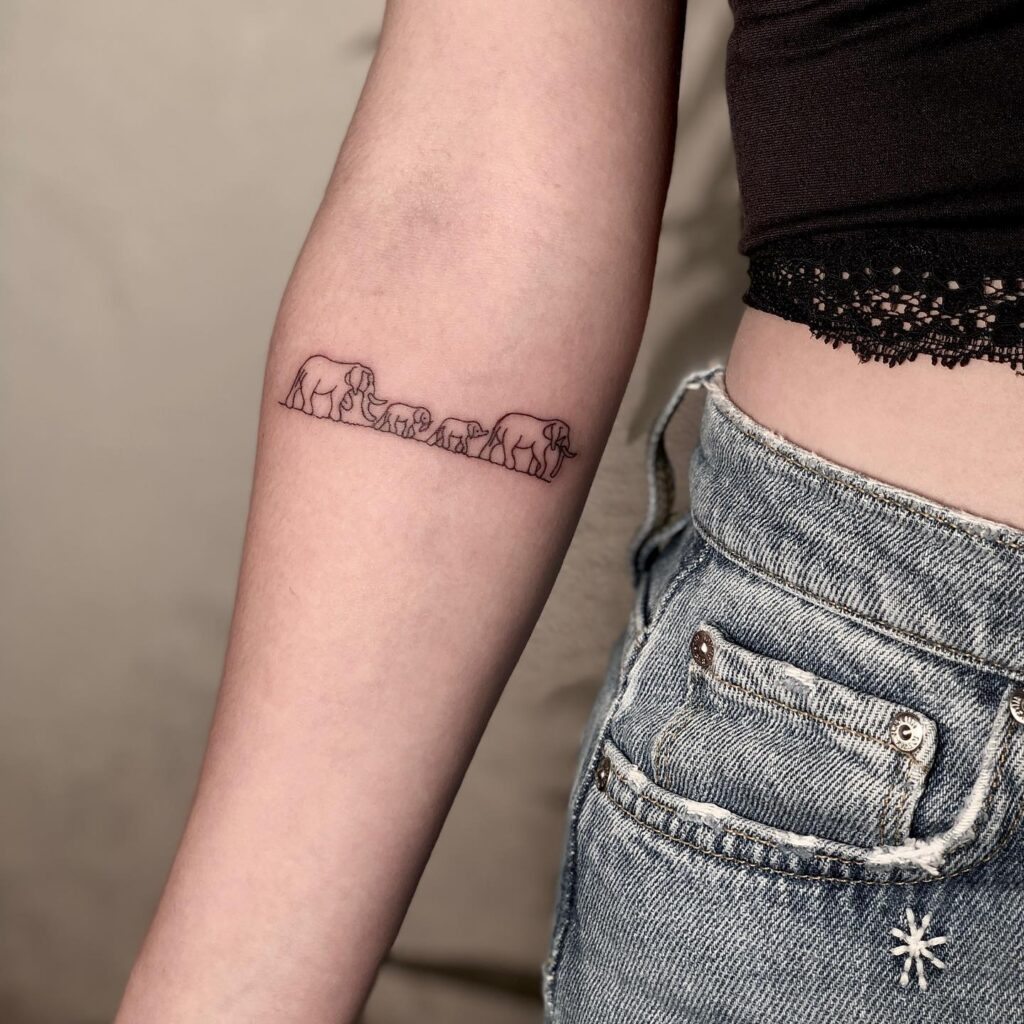Minimalist Four-Elephant Family Tattoo elephant family tattoo ideas tattoo