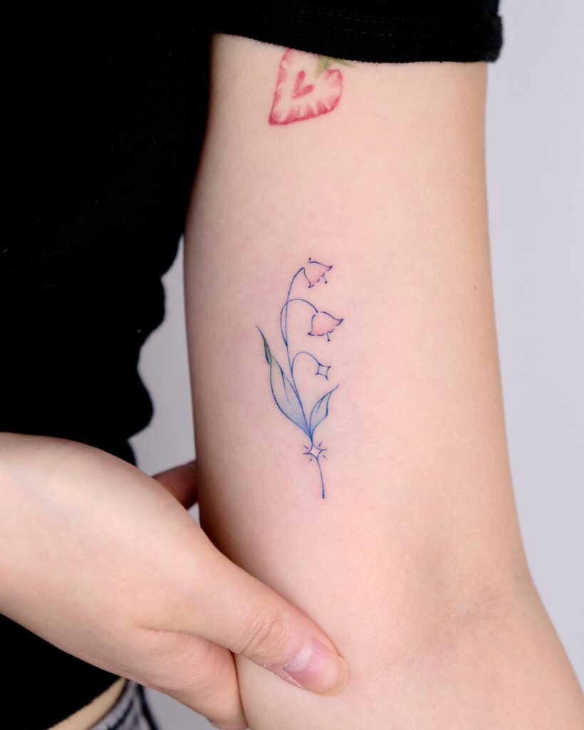 Minimalist Lily of the Valley Tattoo in Soft Colors may birth flower tattoos tattoo