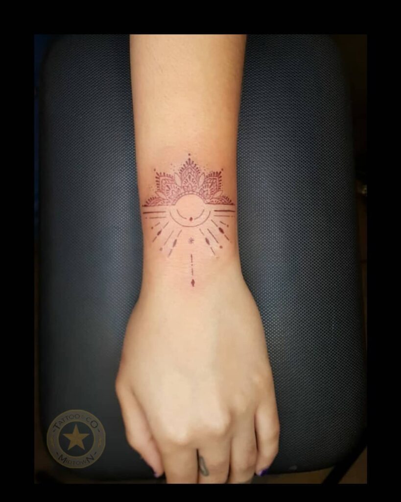 Minimalist Mandala Wrist Tattoo with Radiating Lines mandala wrist tattoo ideas tattoo