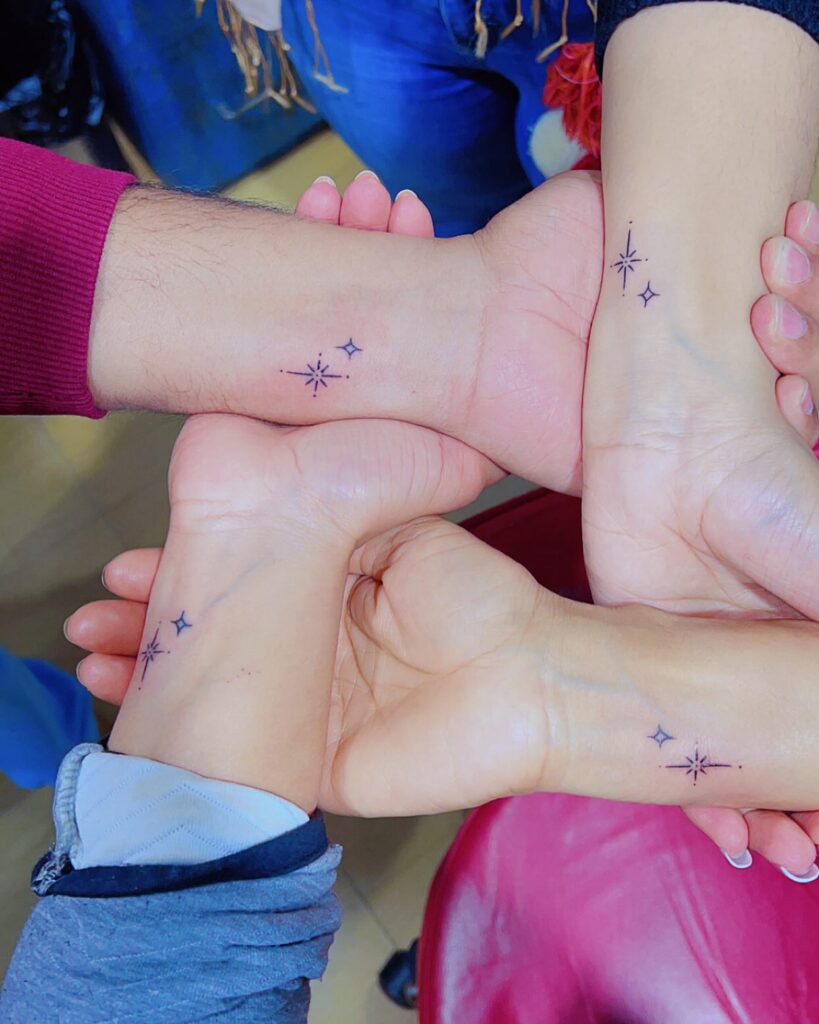 Minimalist Starburst on Opposing Wrists matching family tattoo