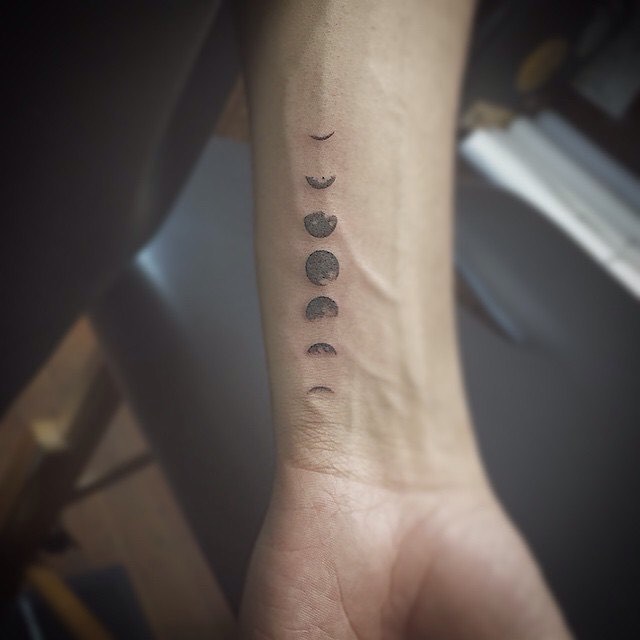 Vertical wrist moon phases tattoo