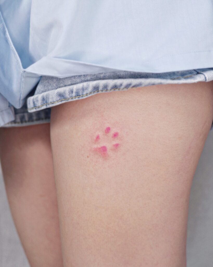 Minimalistic Pink Paw Print Tattoo paw print tattoo ideas tattoo