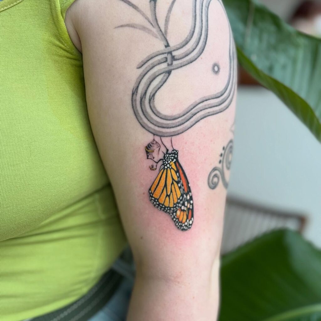 Monarch butterfly tattoo emerging from chrysalis