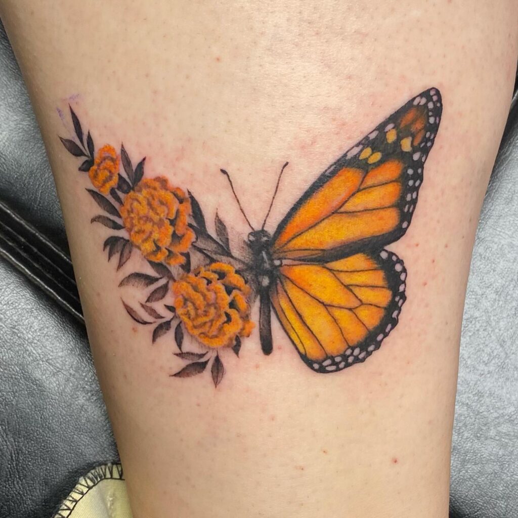 Monarch butterfly with marigolds tattoo