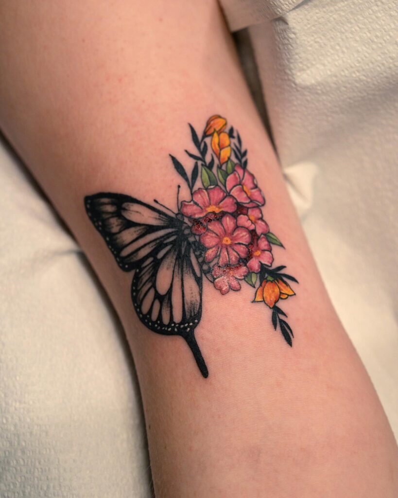 Monochrome Butterfly with Coral and Yellow Blooms Tattoo half butterfly half flower tattoos tattoo