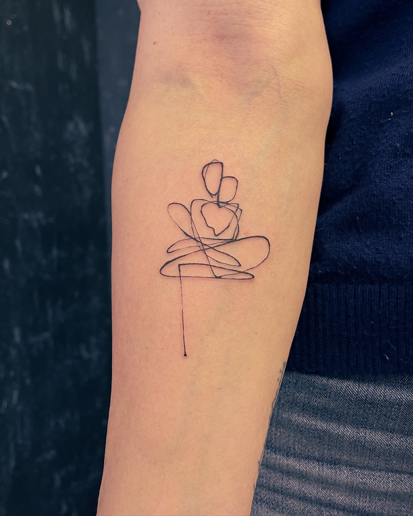 One line mother and child tattoo on forearm
