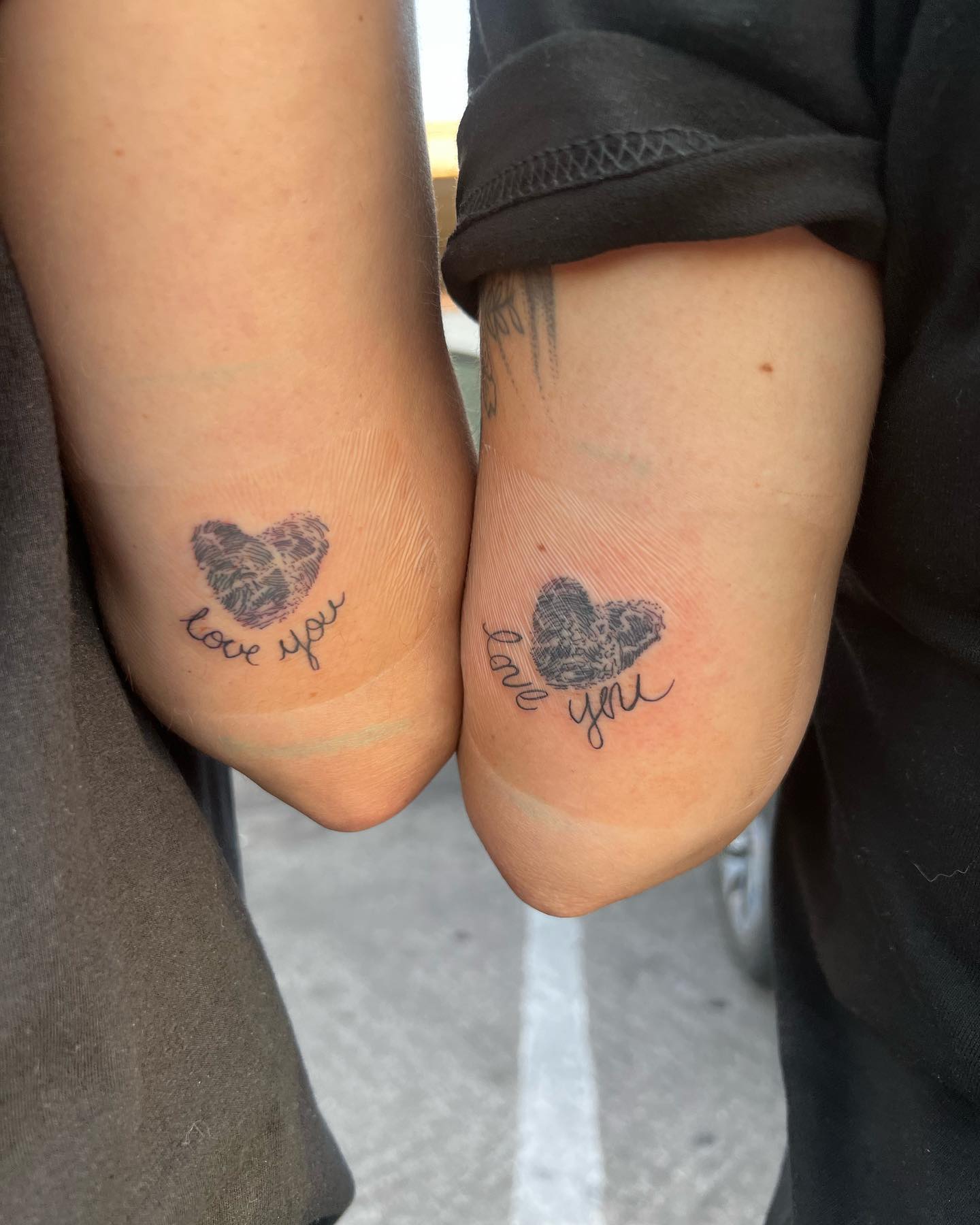 Mother and Daughter Fingerprint Heart Tattoos with “Love You” Script unique mom and daughter tattoos tattoo