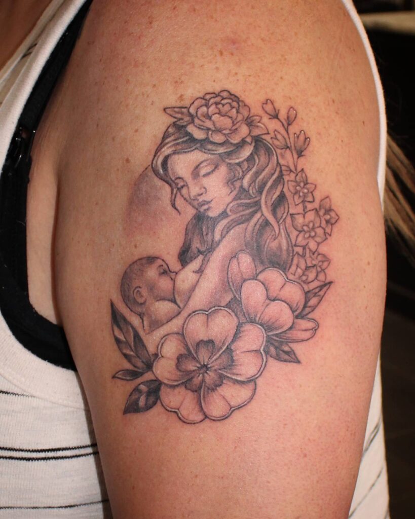 Mother Breastfeeding Surrounded by Flowers Tattoo mommy tattoo ideas tattoo