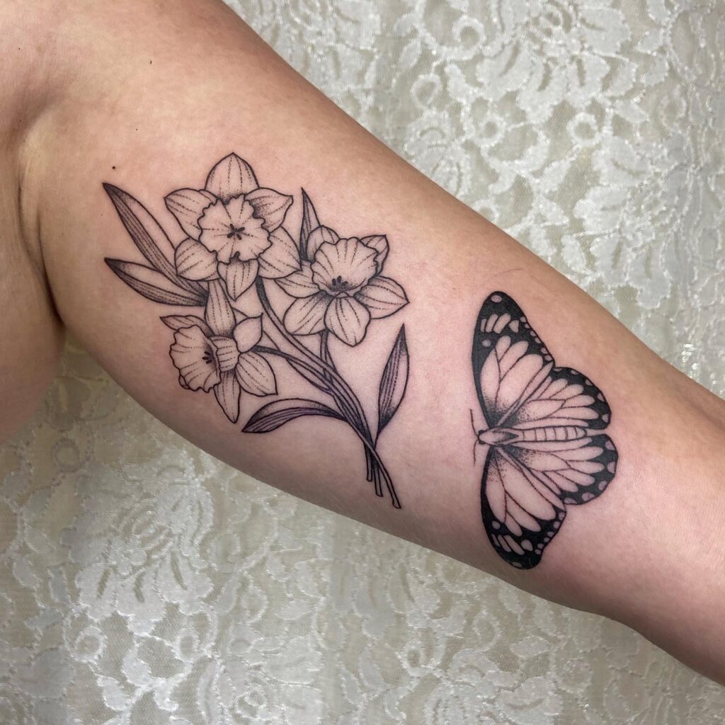 Narcissus and Butterfly Tattoo in Fine Line Style december birth flower tattoo ideas tattoo