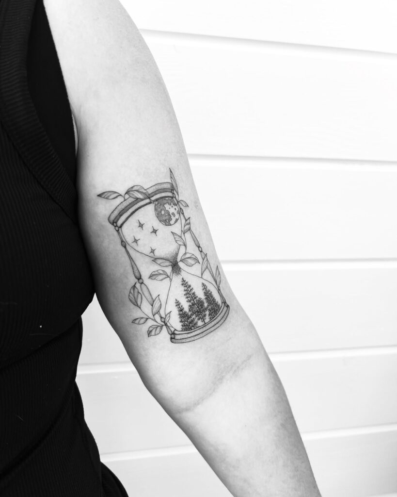 Nature-Filled Hourglass Arm Tattoo hourglass tattoo ideas tattoo