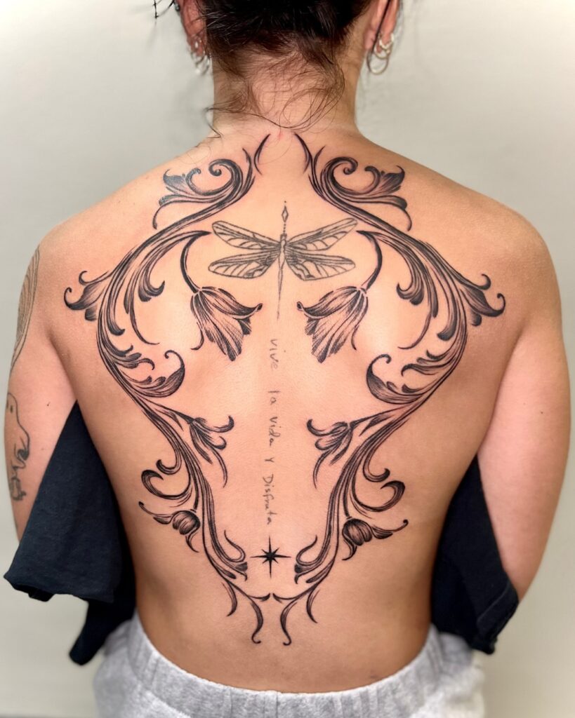 Geometric Blackwork Back Tattoo With Floral Accents