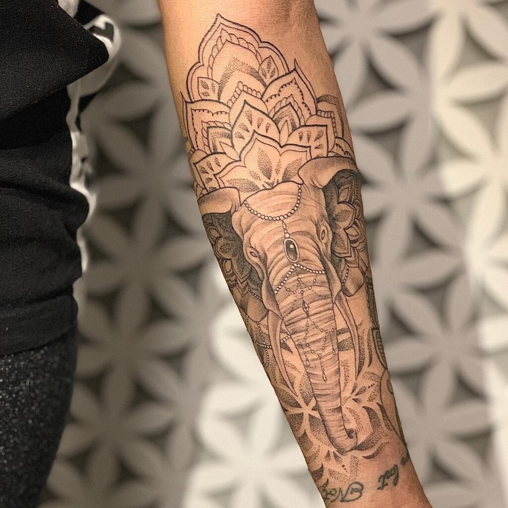 Intricate elephant mandala sleeve tattoo with ornamental details