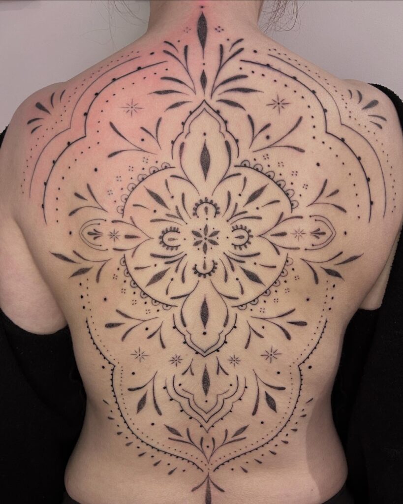 Elegant Ornamental Spine Tattoo With Celestial Touches