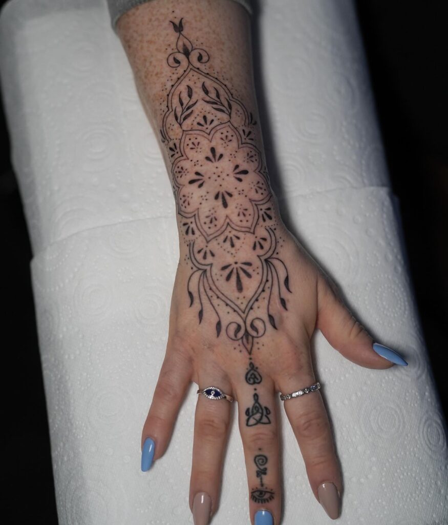 Ornamental Mandala-Inspired Hand and Wrist Tattoo mandala wrist tattoo ideas tattoo