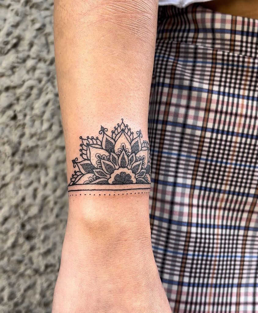 Ornamental Mandala Wrist Tattoo with Dotted Accents mandala wrist tattoo ideas tattoo