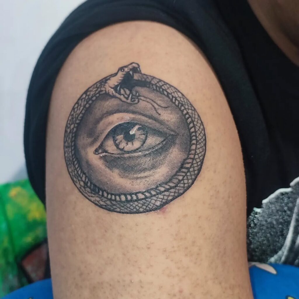Bold Black Chest Ouroboros Tattoo With Tribal Twist