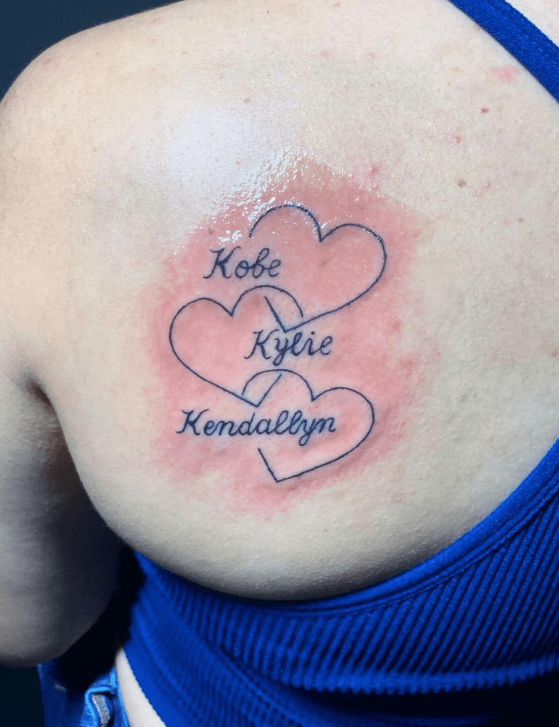 Overlapping Sibling Hearts with Cursive Script kids name tattoo