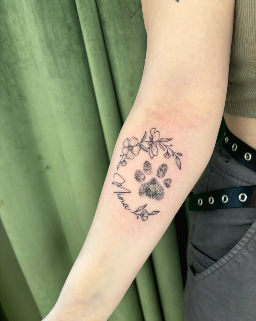 Paw Print Tattoo with Floral Accent and Name paw print tattoo ideas tattoo