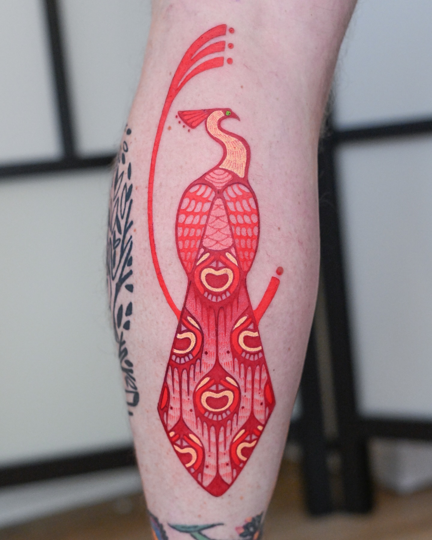 Geometric Red Peacock Tattoo