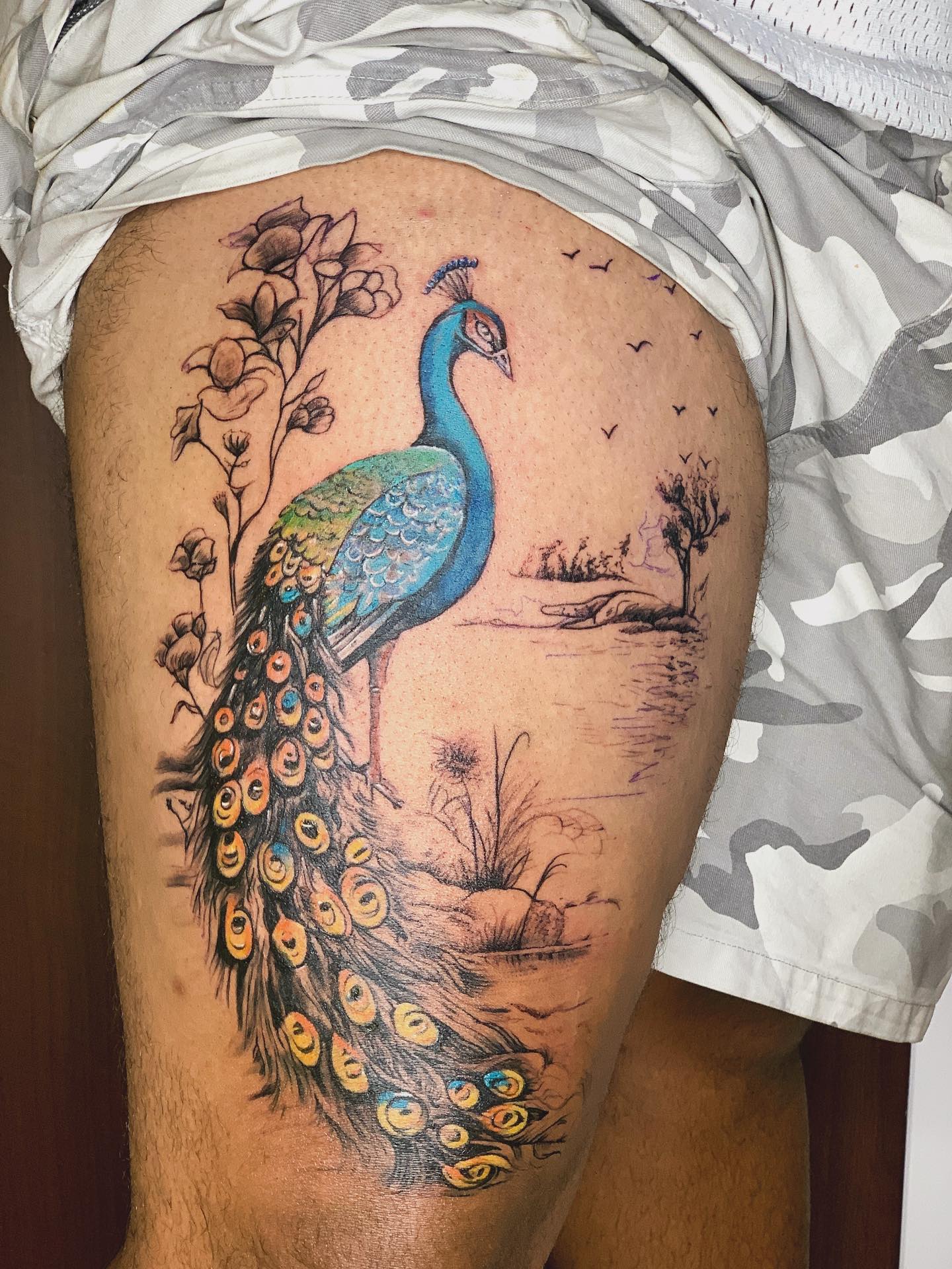 Scenic Peacock Tail Tattoo