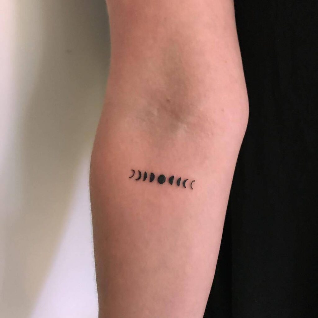 Petite moon phases arm tattoo