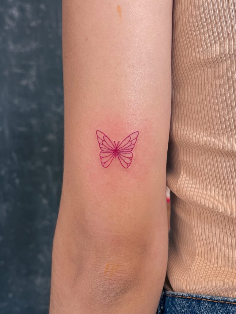 Pink Fine Line Butterfly Tattoo on Arm fine line tattoos for women tattoo