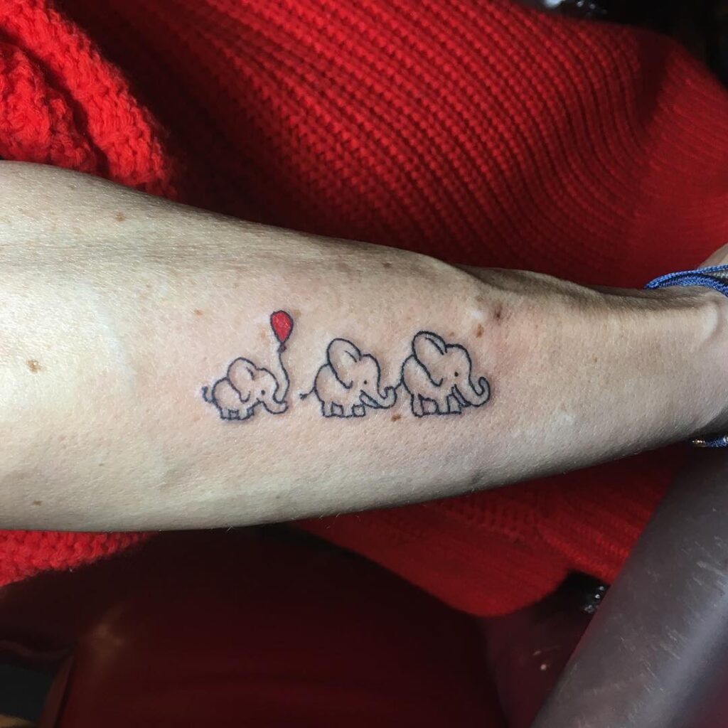 Playful Elephant Trio with Balloon Tattoo elephant family tattoo ideas tattoo