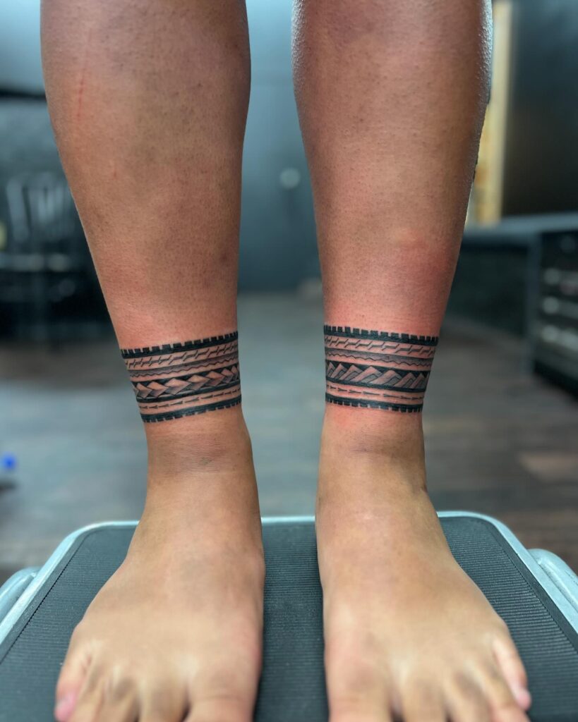 Tribal Chest And Sleeve Tattoo