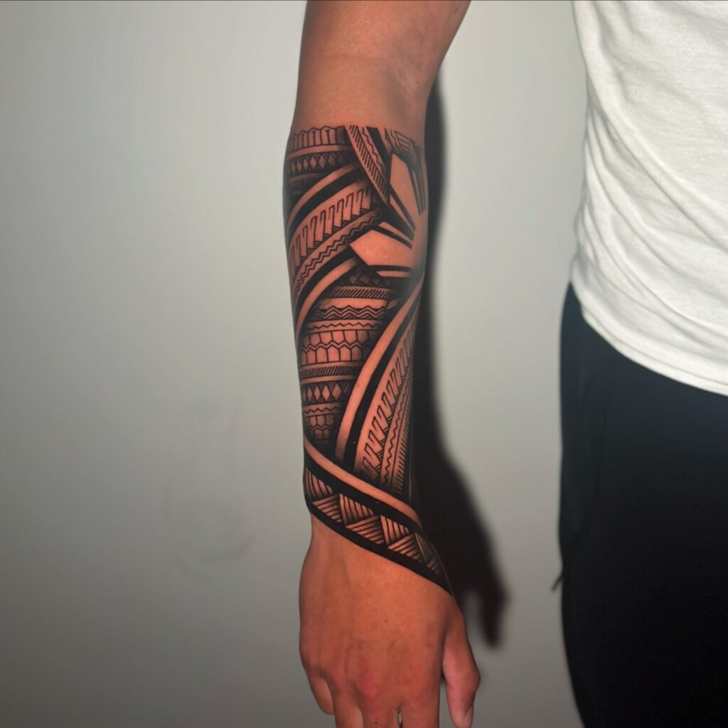 Samoan-Inspired Chest And Sleeve Tattoo
