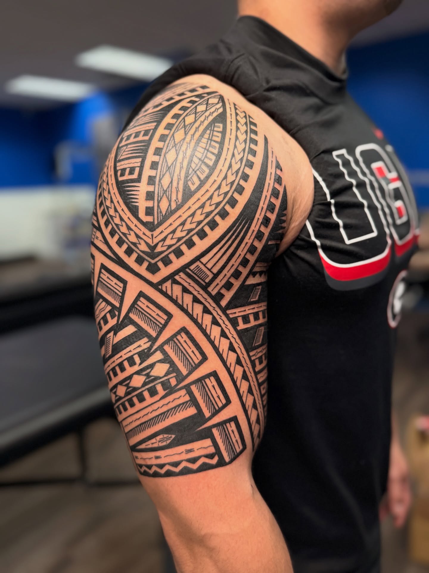 Layered Polynesian Upper Arm Tattoo