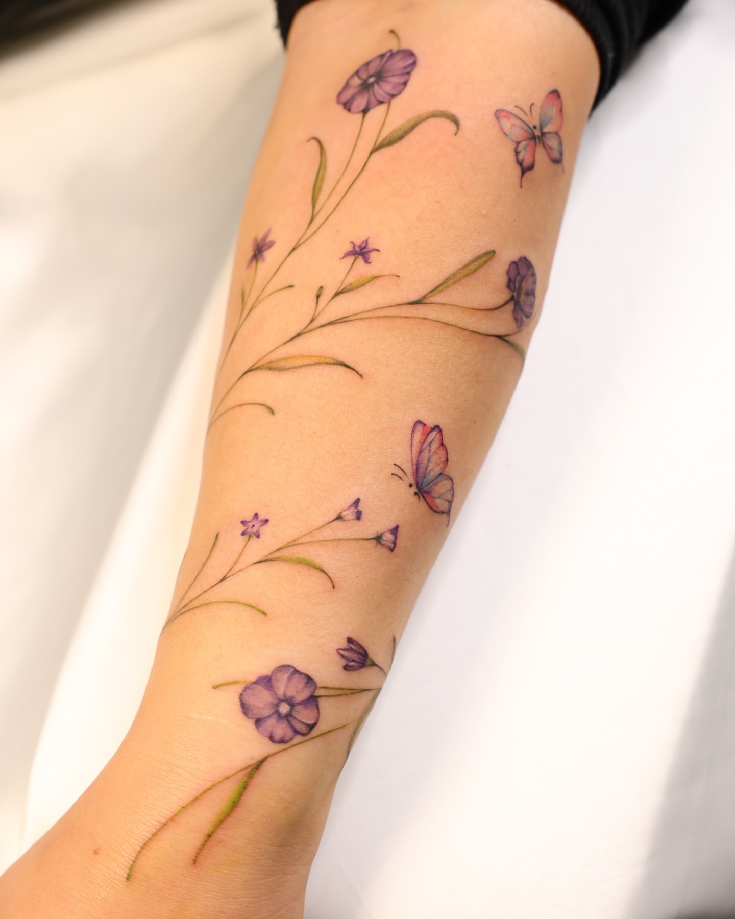Minimalist Vine Tattoo Flowing from Arm to Hand vine tattoos tattoo