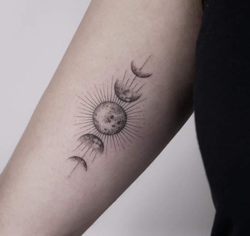 Radiant sun and moon phases tattoo with geometric rays