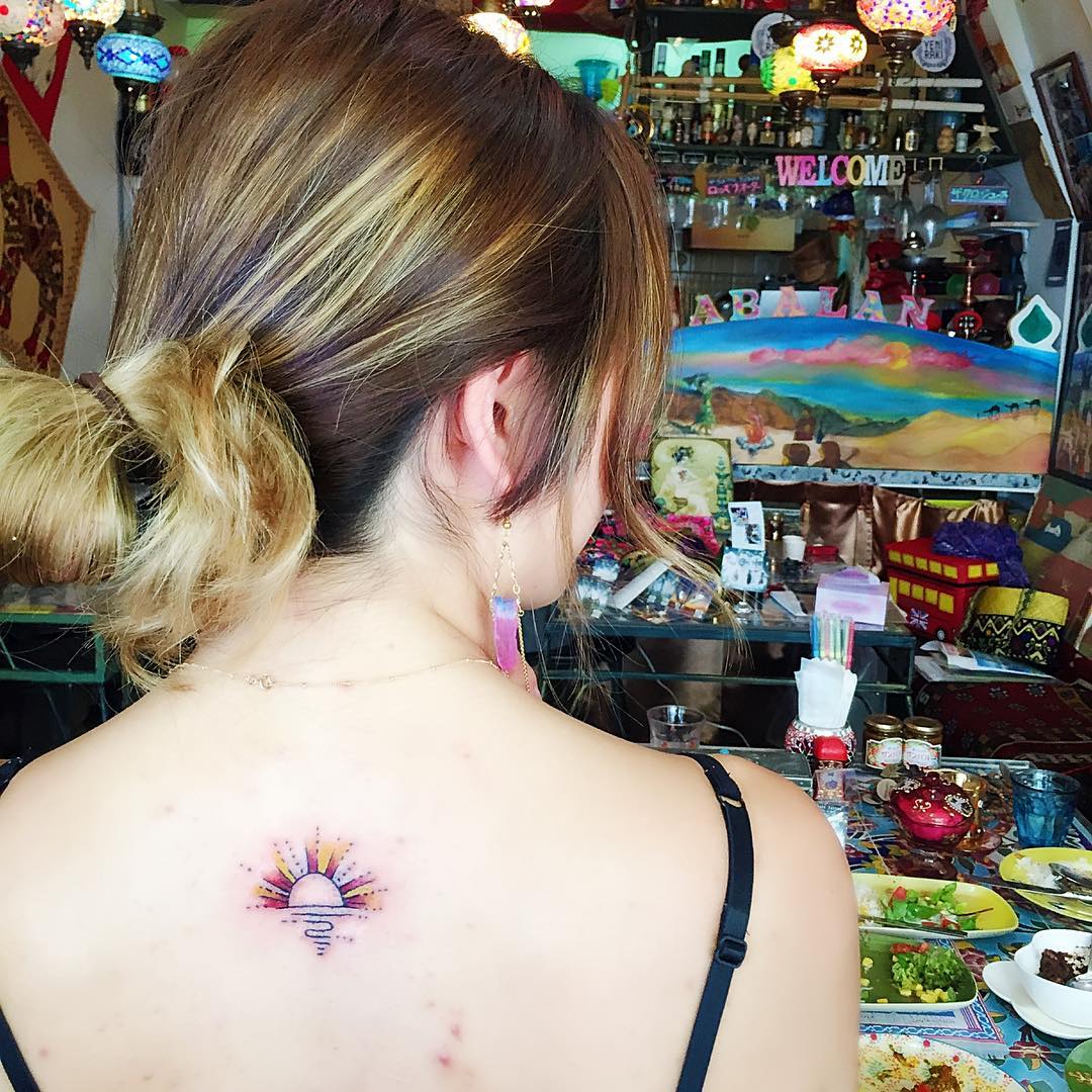 Radiant Sunrise Across the Upper Back sunrise tattoo