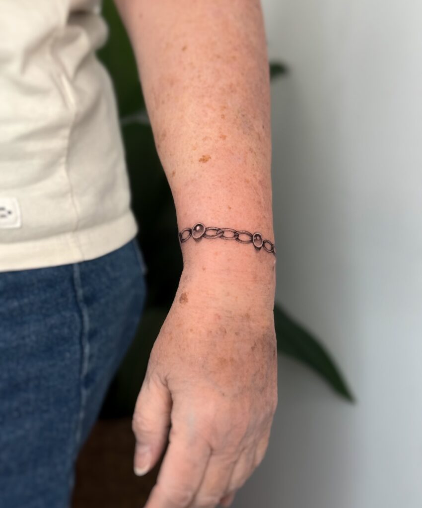 Rosary-Inspired Cross Bracelet Tattoo