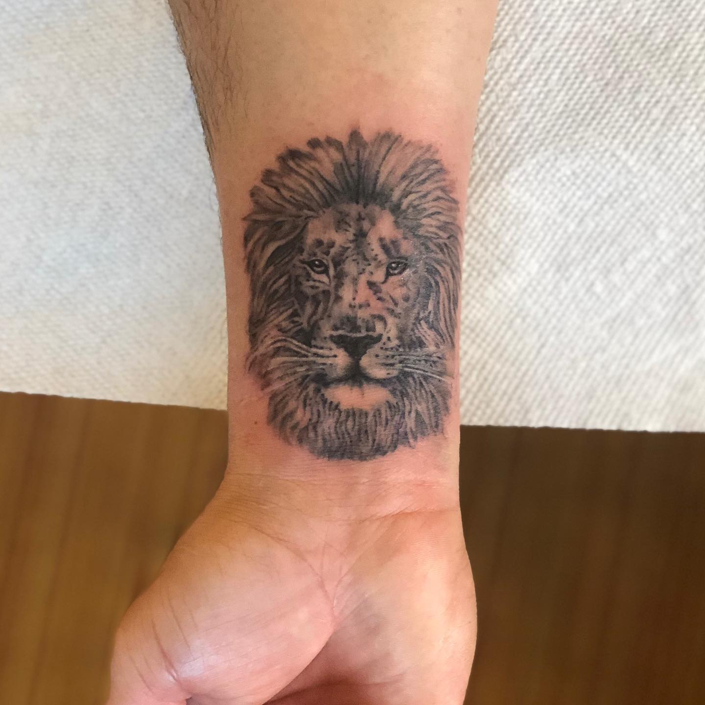 Realistic Lion Head Wrist Tattoo