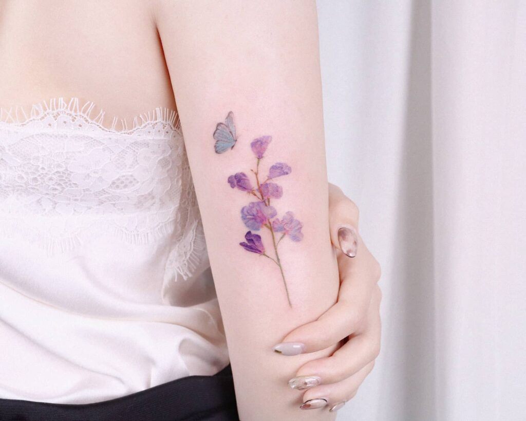 Realistic Sweet Pea Tattoo with Butterfly april birth flower tattoo ideas tattoo