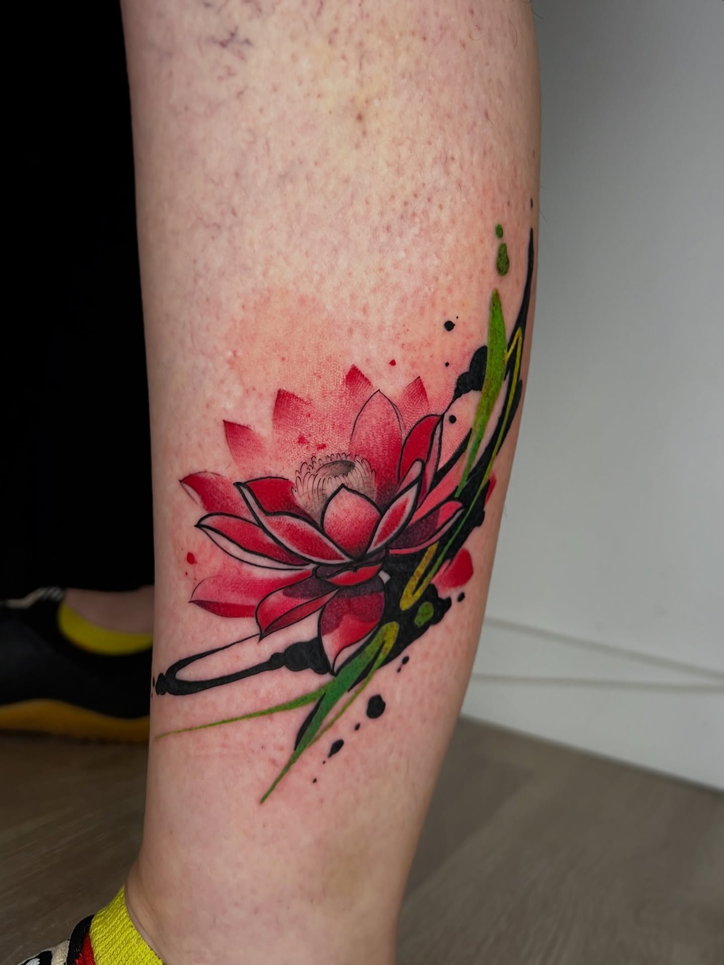 Red Lotus Flower Tattoo With Abstract Brushstrokes lotus flower tattoo ideas meaning tattoo