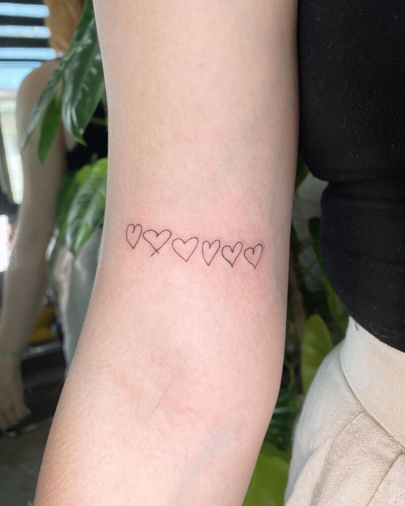 Two-Tone Heart Outline on Wrist small heart tattoo ideas tattoo